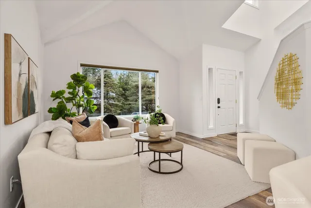 a living room with furniture and a mirror