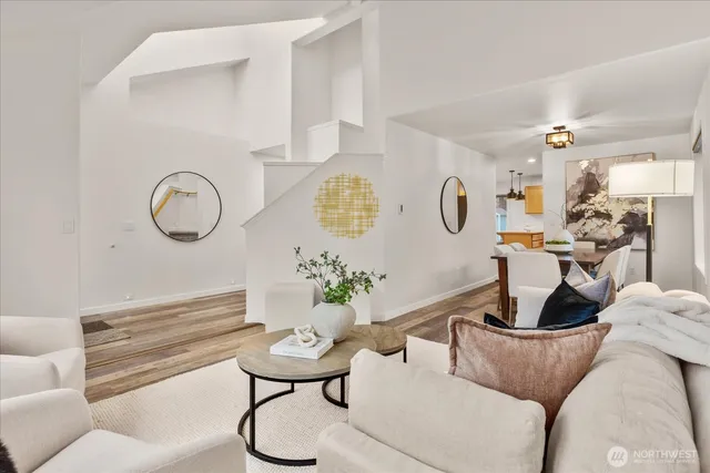 a living room with furniture potted plant and a fireplace