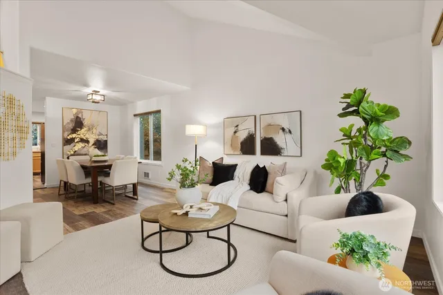 a dining room with furniture a chandelier and wooden floor