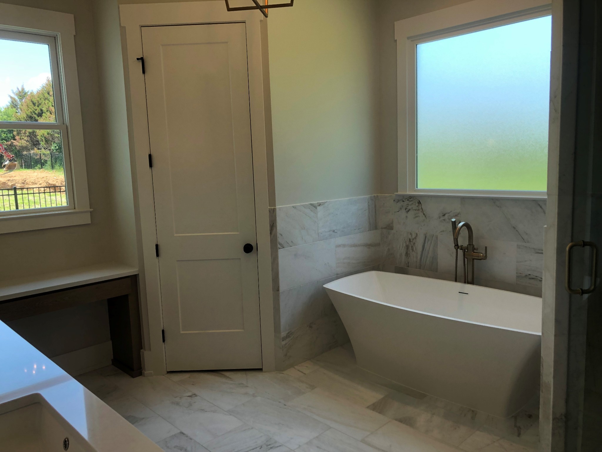3073 Long Branch Circle Franklin, TN 37064 - Photo 7 of 13 a white bath tub sitting in a bathroom next to a window