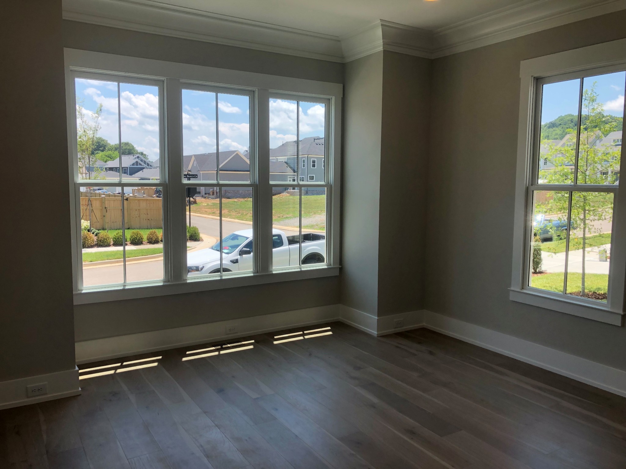 3073 Long Branch Circle Franklin, TN 37064 - Photo 10 of 13 an empty room with wooden floor and windows