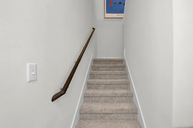 a bedroom with a bed and ceiling fan