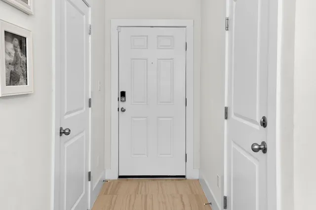 a view of a hallway with wooden floor