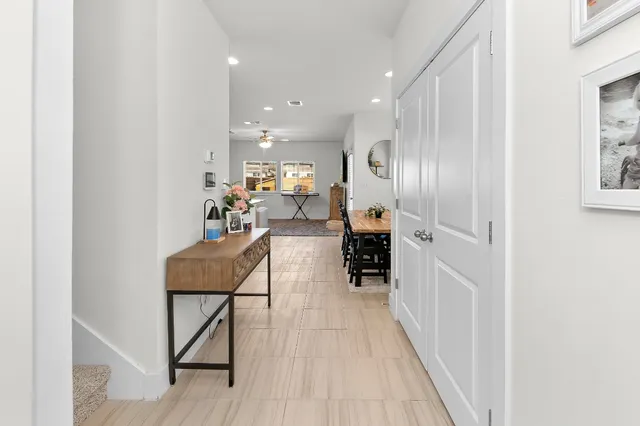 a hallway with chairs a washer and dryer