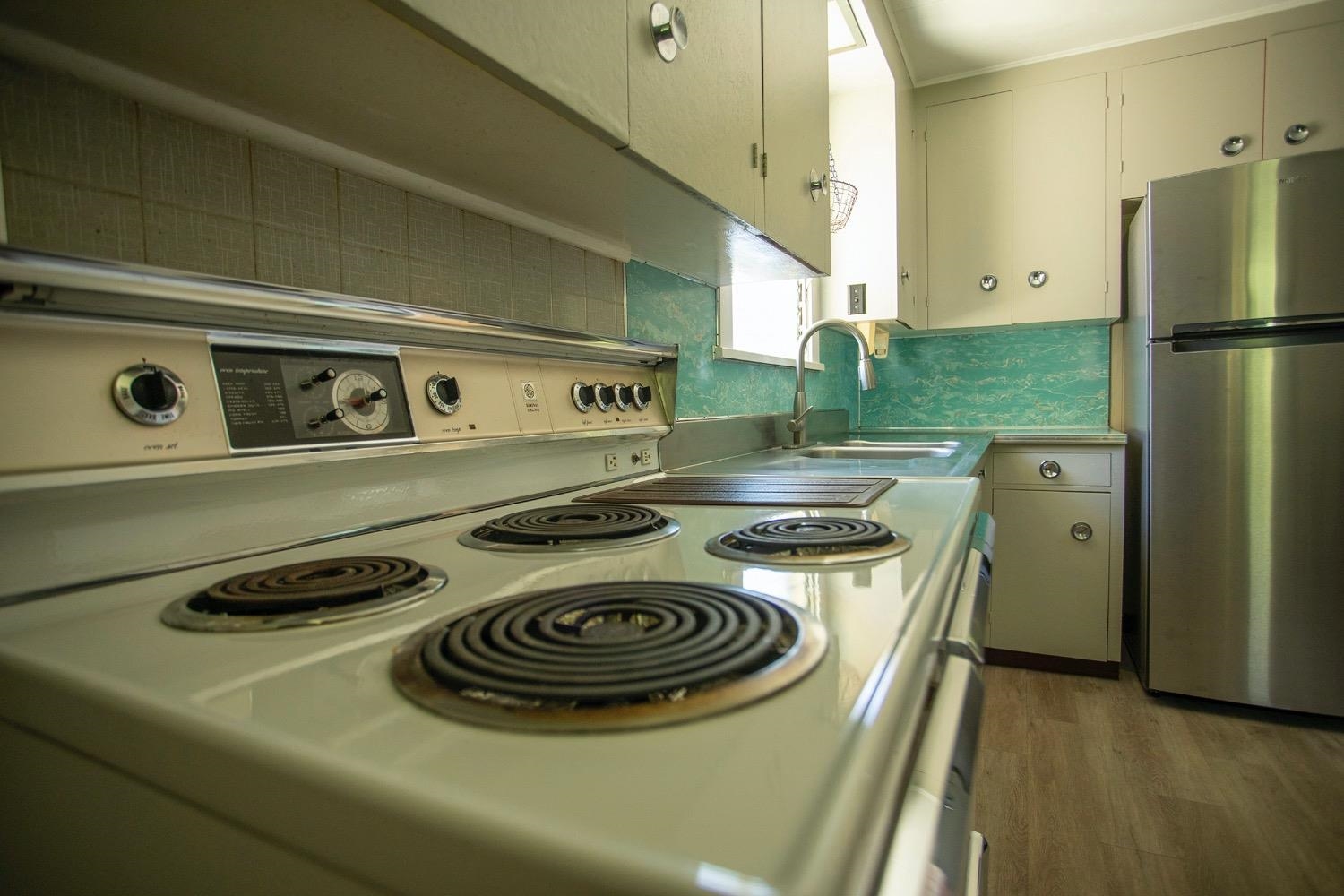 741 Haiku Road Haiku, HI 96708 - Photo 13 of 26 a kitchen with a stove and a refrigerator