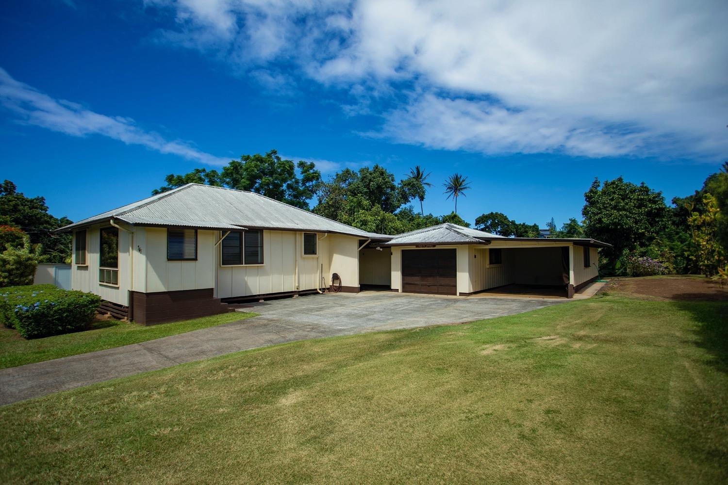 741 Haiku Road Haiku, HI 96708 - Photo 3 of 26 a front view of a house with a garden