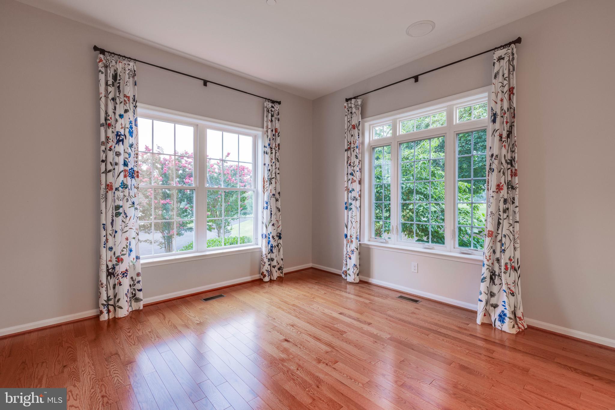 3913 Briar Knoll Circle Phoenix, MD 21131 - Photo 16 of 39 a view of an empty room with wooden floor and a window