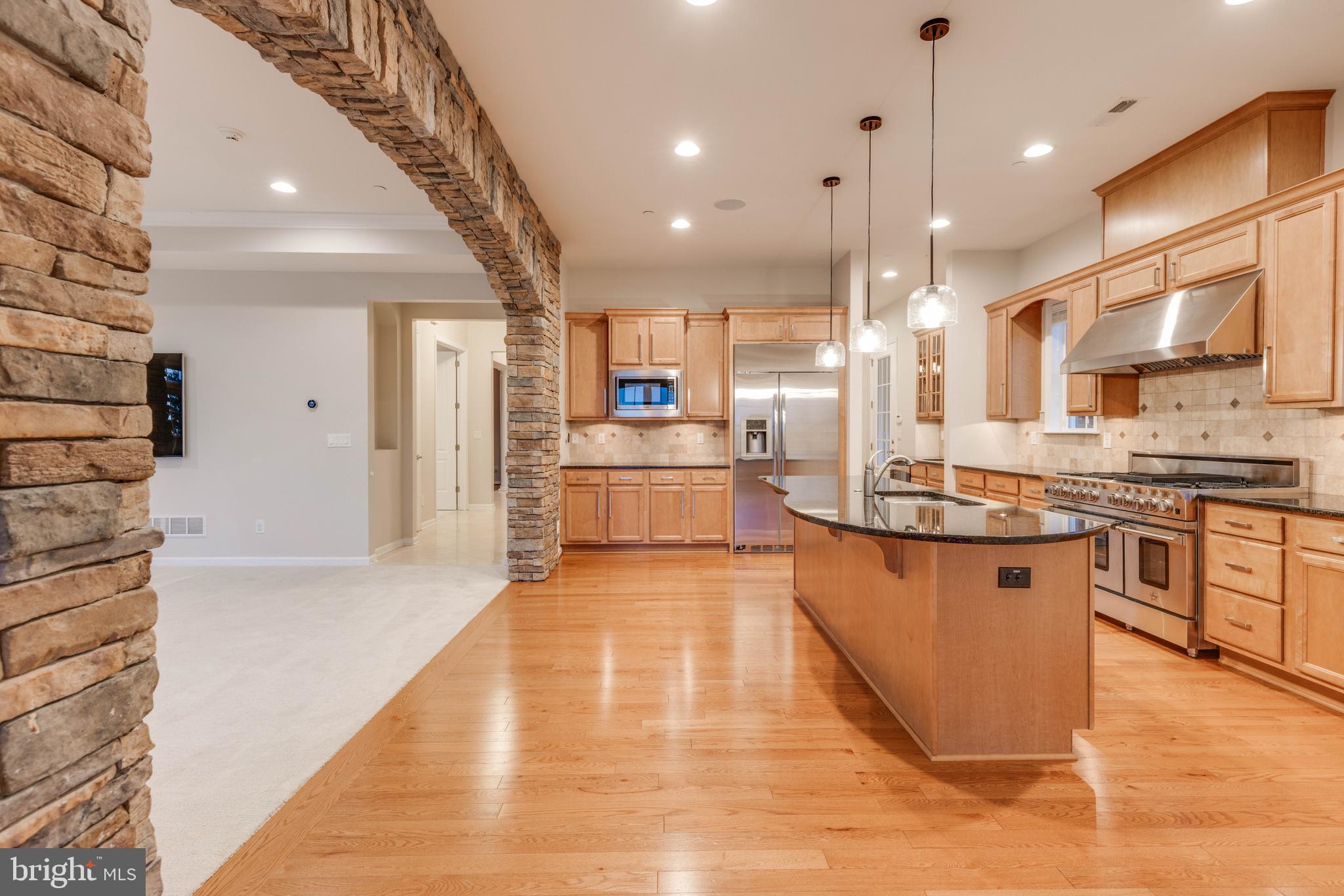 3913 Briar Knoll Circle Phoenix, MD 21131 - Photo 21 of 39 a large kitchen with stainless steel appliances kitchen island a large counter top a stove and a refrigerator