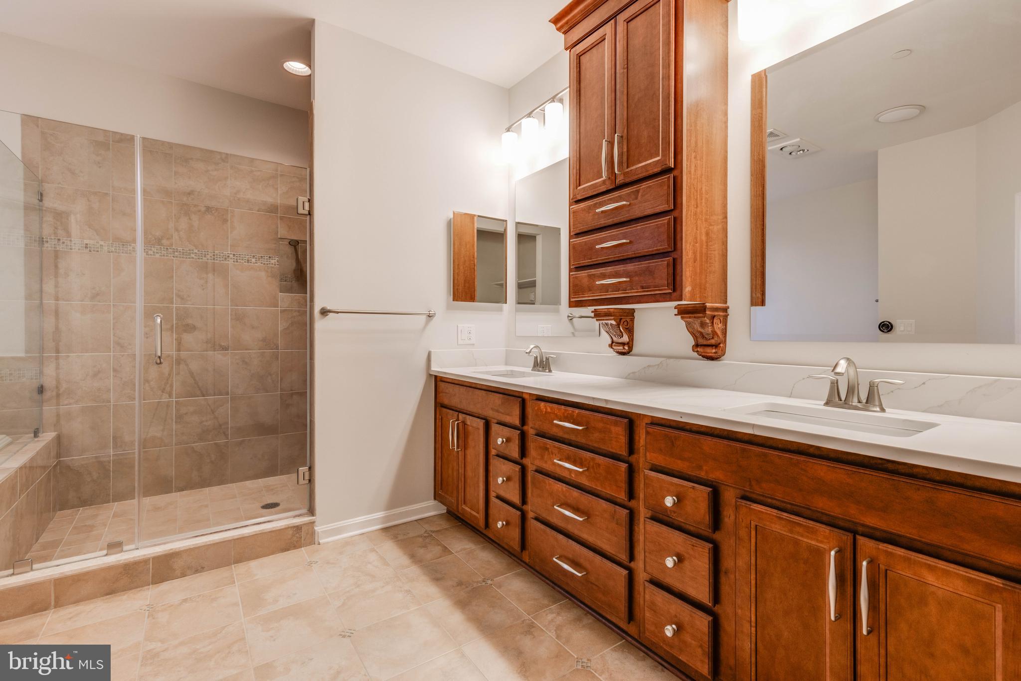 3913 Briar Knoll Circle Phoenix, MD 21131 - Photo 29 of 39 a bathroom with a double vanity sink mirror and shower