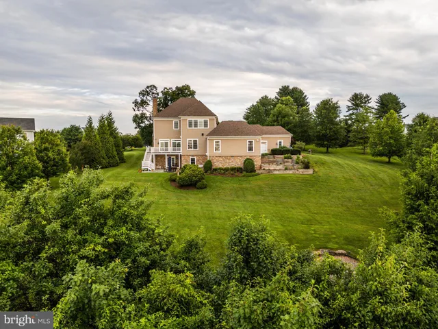 a bathroom with a granite countertop sink a toilet and a shower