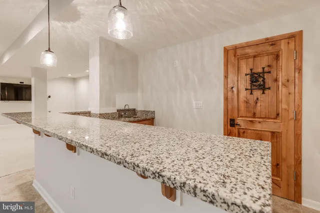 a view of staircase with wooden floor and white walls