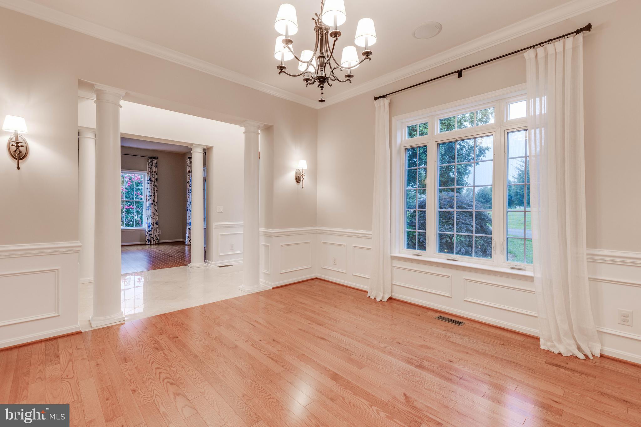 3913 Briar Knoll Circle Phoenix, MD 21131 - Photo 7 of 39 wooden floor in an empty room with a window