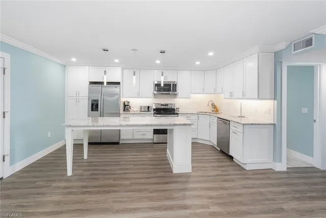 a kitchen with white cabinets and white appliances