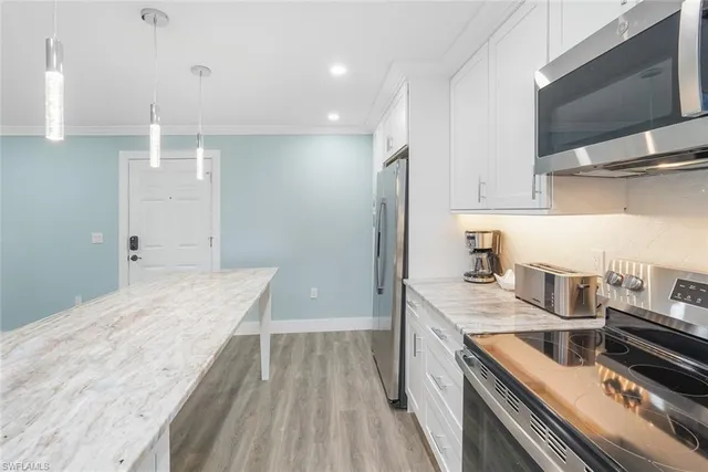 a kitchen with a sink stove and microwave