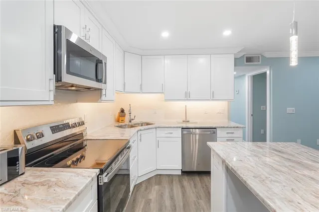 a kitchen with a stove a sink and a microwave
