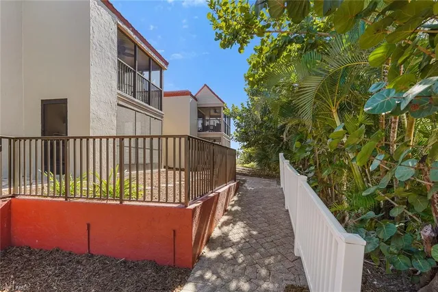 a balcony with wooden fence and trees