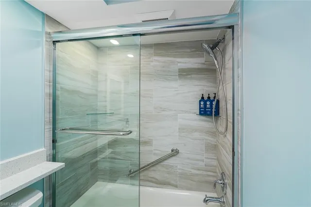 a bathroom with a glass shower door