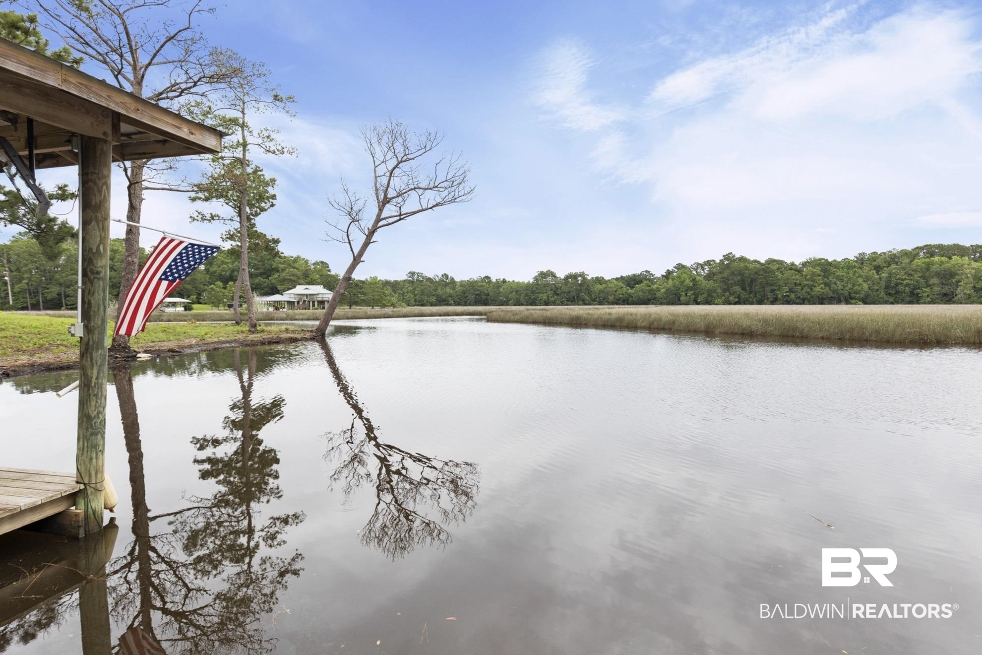 12171 Marguerite Drive Coden, AL 36523 - Photo 24 of 44 Waterfront property featuring a private wooden dock, tranquil water, and lush marshland