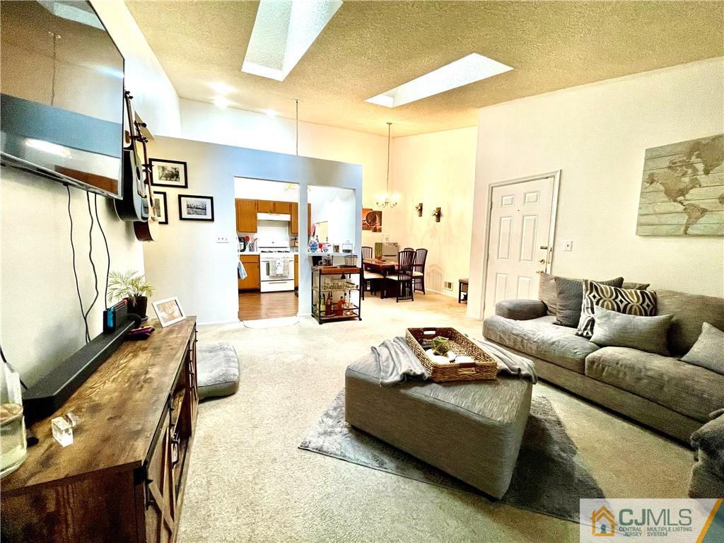 341 Wimbeldon Court North Brunswick, NJ 08902 - Photo 4 of 16 a living room with furniture and a flat screen tv