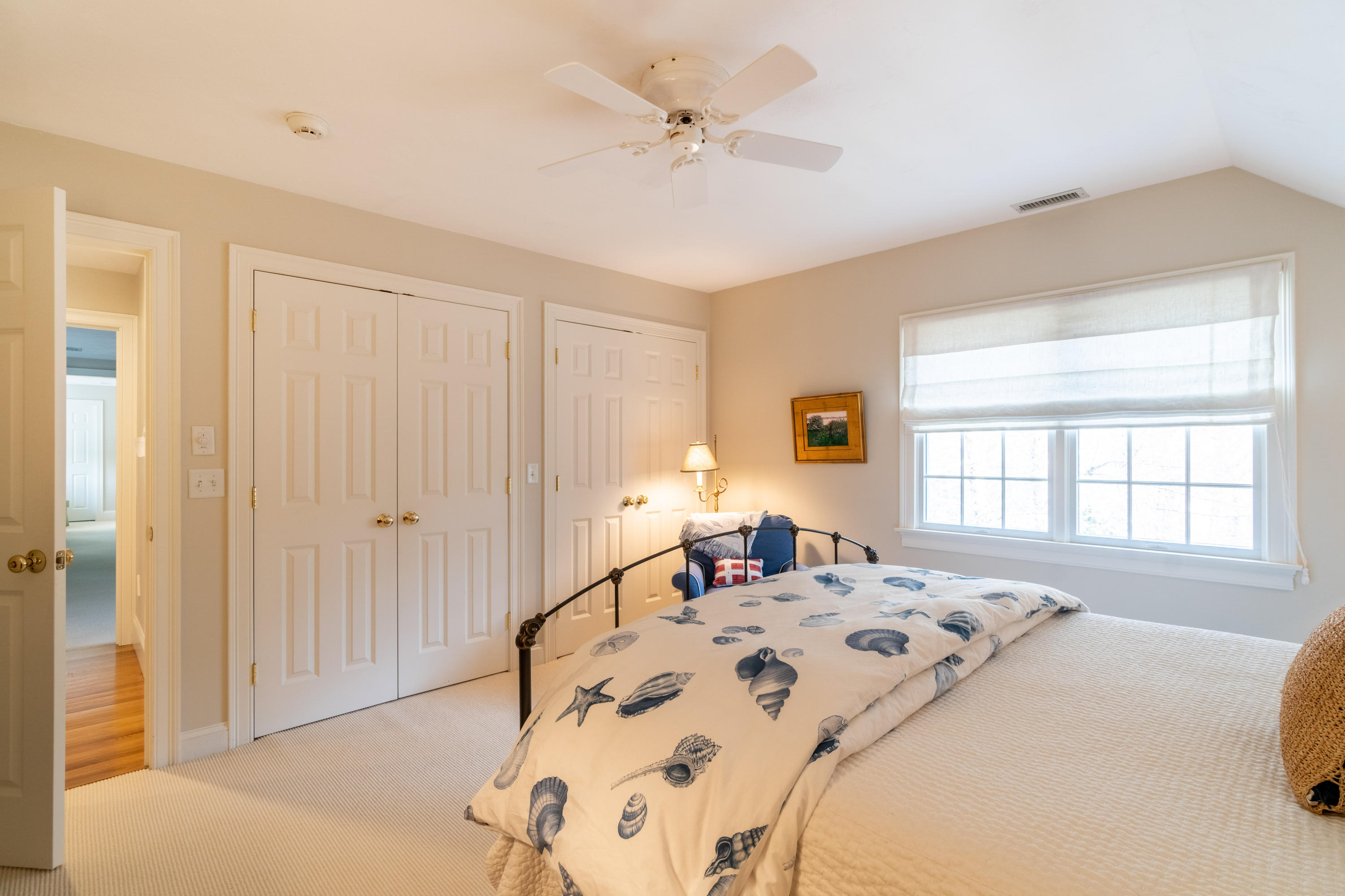 150 Training Field Road Chatham, MA 02633 - Photo 22 of 42 a spacious bedroom with a bed a couch and a window