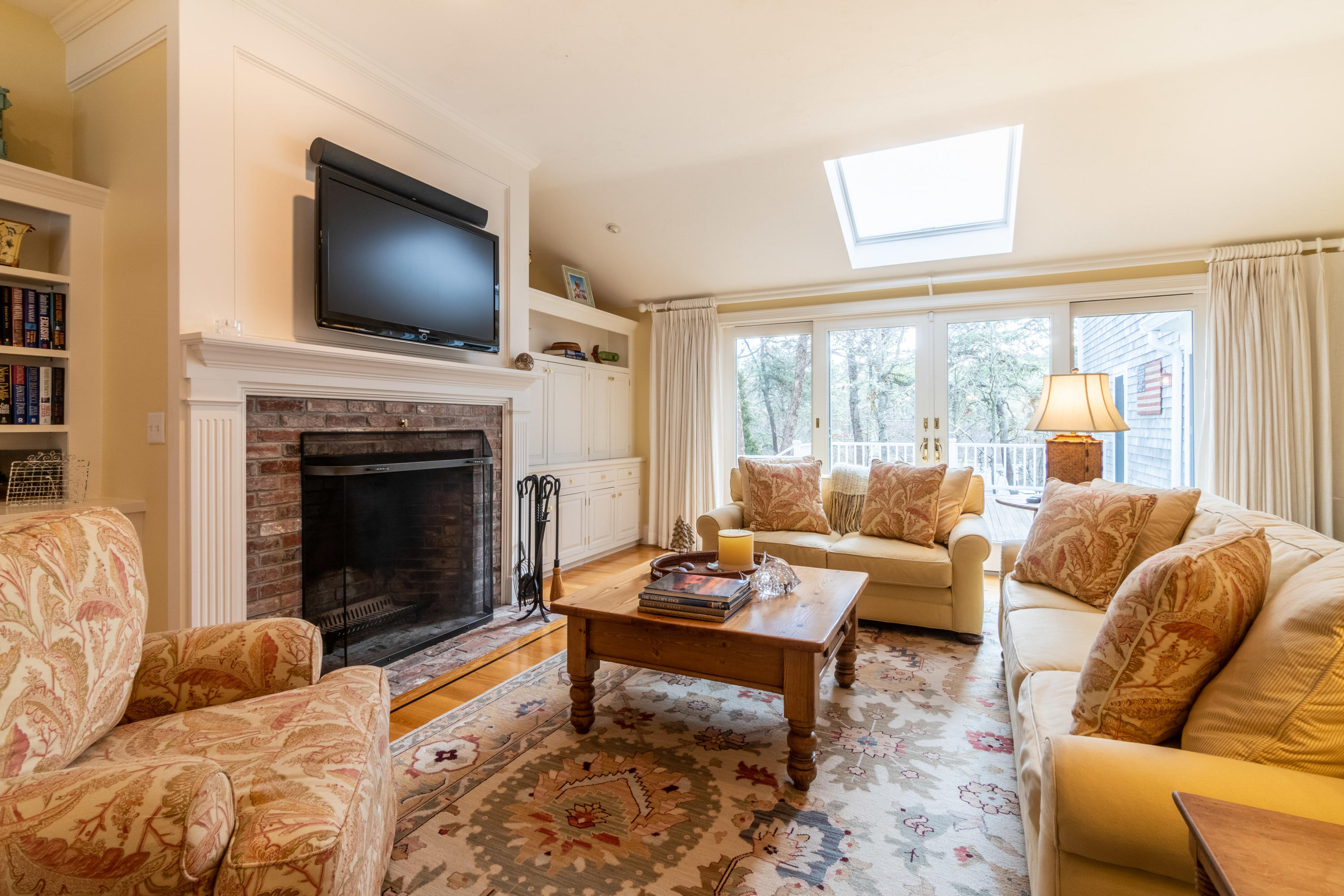 150 Training Field Road Chatham, MA 02633 - Photo 29 of 42 a living room with furniture a flat screen tv and a fireplace