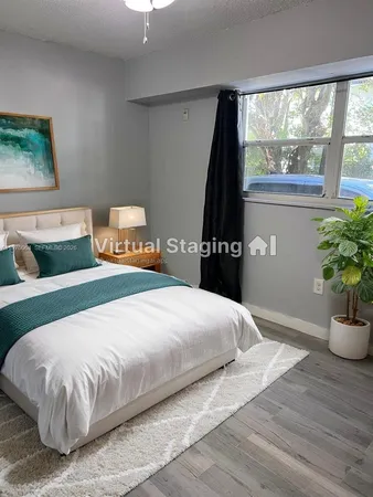 a bedroom with a bed and a potted plant