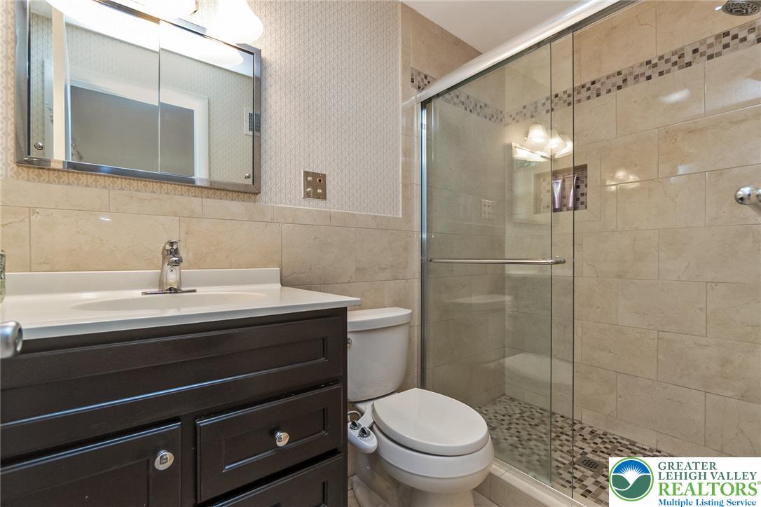 525 Wedgewood Road Bethlehem, PA 18017 - Photo 31 of 61 An updated primary bathroom features a modern vanity and a spacious, glass-enclosed shower.