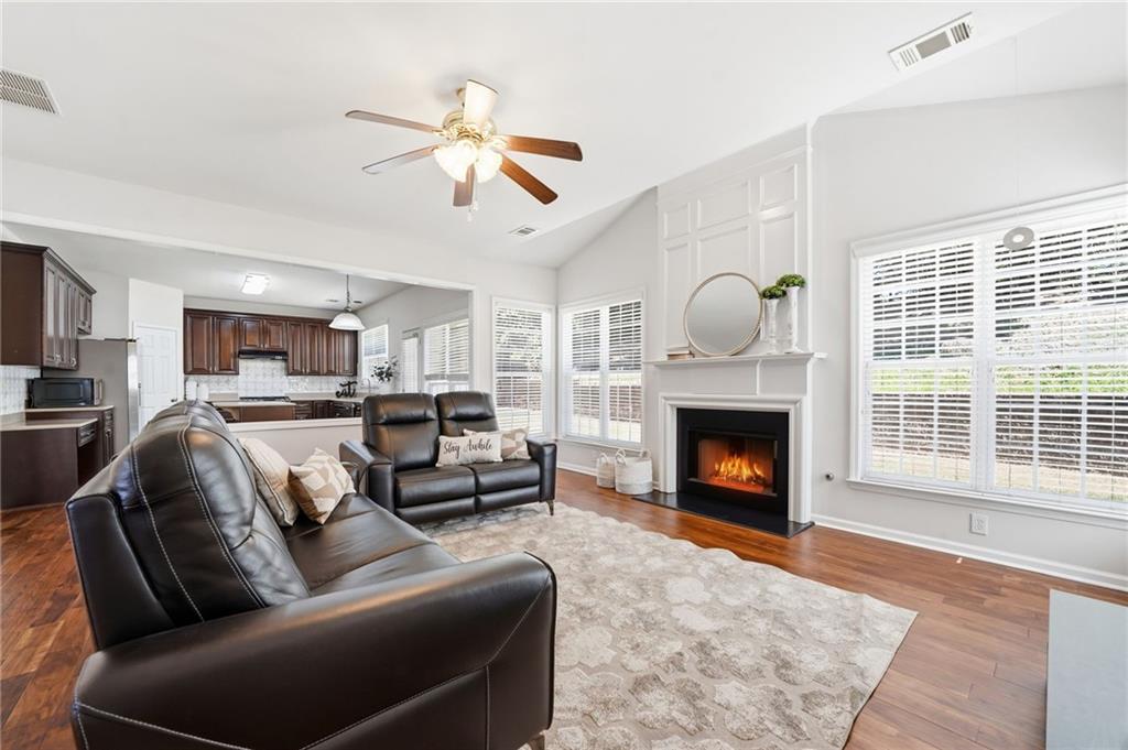 310 Hammersmith Drive Suwanee, GA 30024 - Photo 19 of 55 a living room with furniture a fireplace and a fireplace
