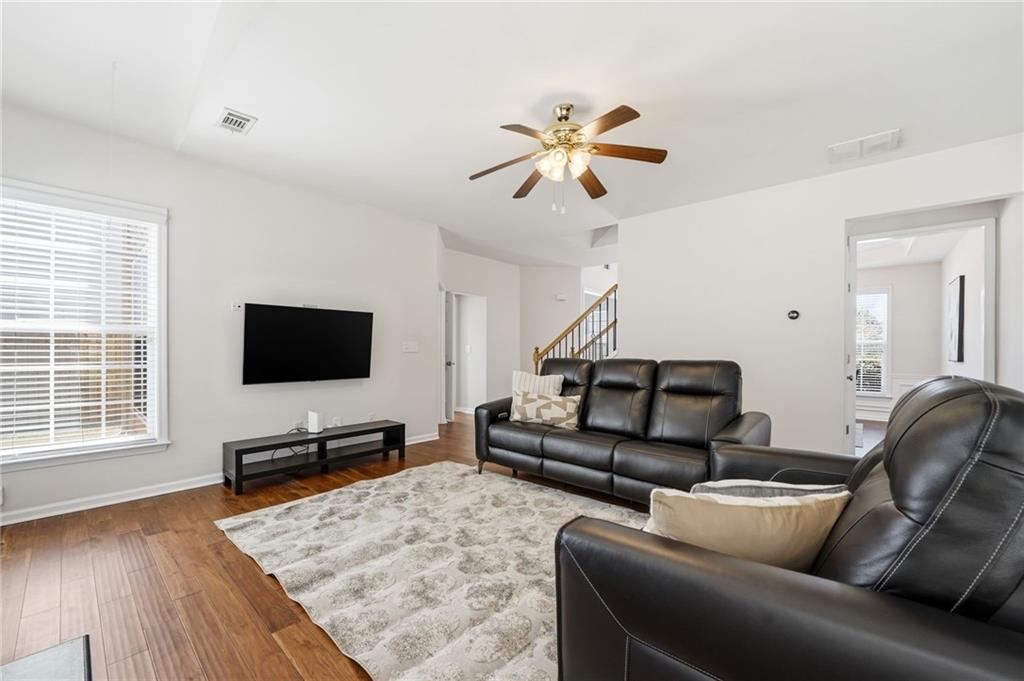 310 Hammersmith Drive Suwanee, GA 30024 - Photo 20 of 55 a living room with furniture and a flat screen tv