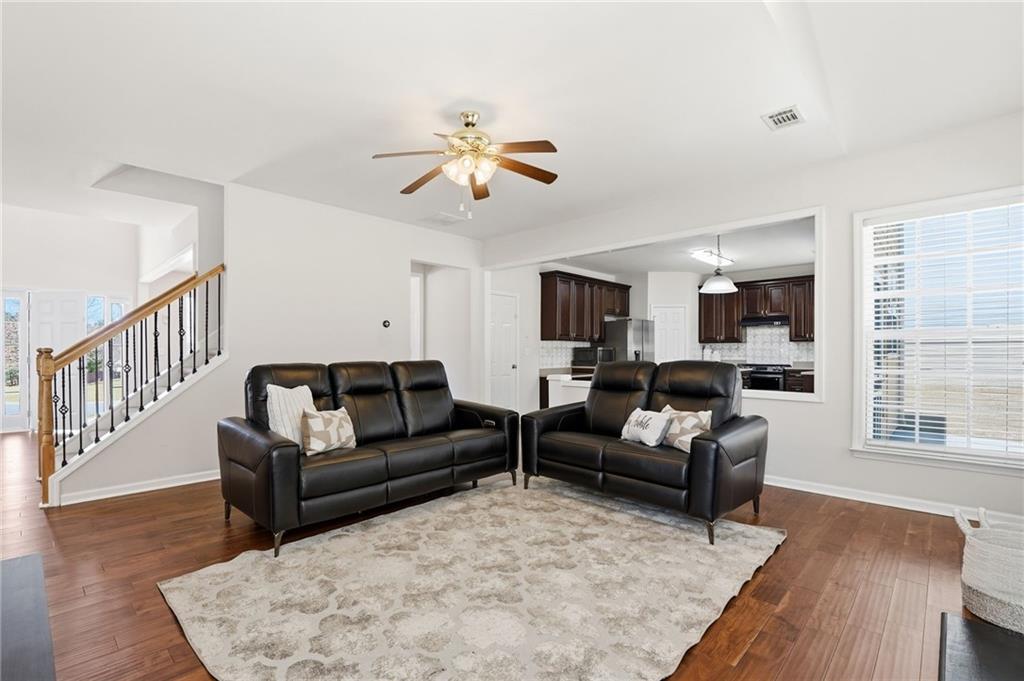 310 Hammersmith Drive Suwanee, GA 30024 - Photo 21 of 55 a living room with furniture or couch and a wooden floor