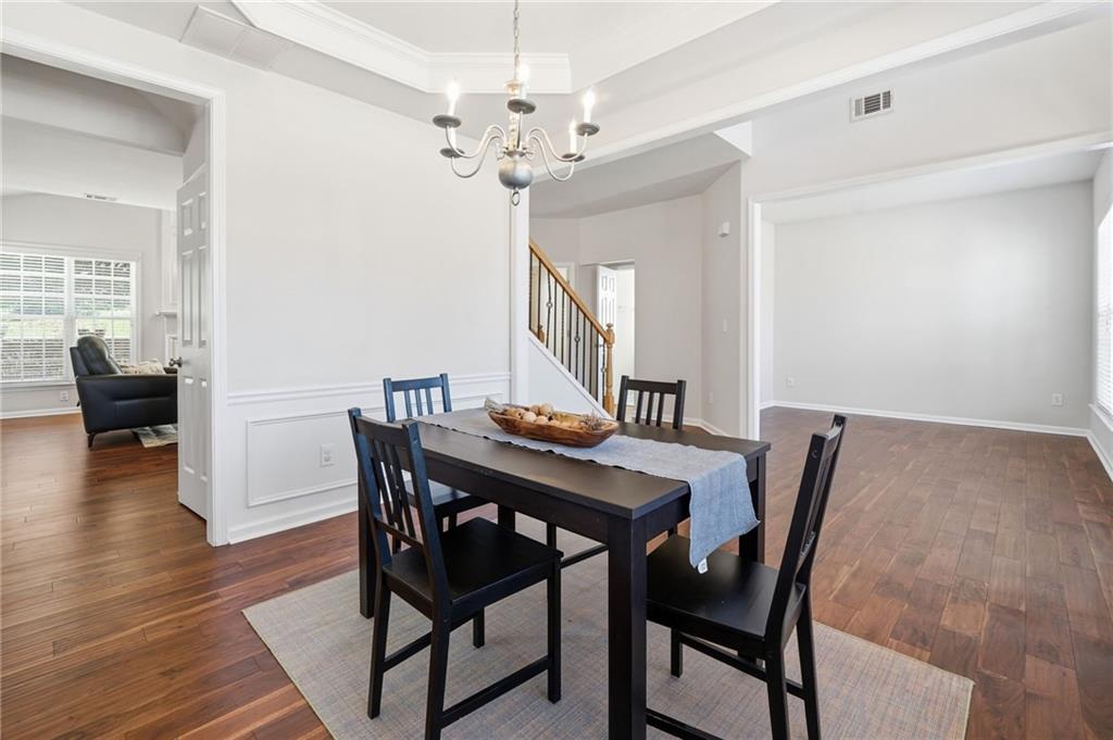 310 Hammersmith Drive Suwanee, GA 30024 - Photo 22 of 55 a view of a dining room with furniture and wooden floor