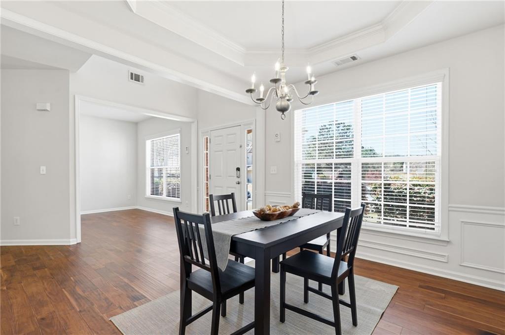 310 Hammersmith Drive Suwanee, GA 30024 - Photo 23 of 55 a view of a dining room with furniture window and wooden floor