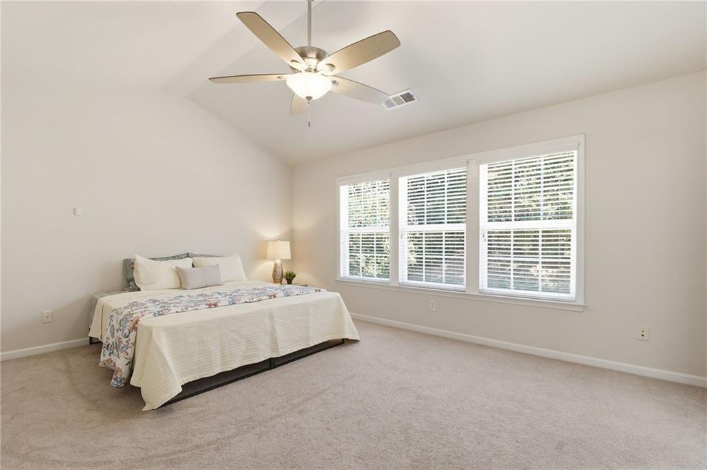 310 Hammersmith Drive Suwanee, GA 30024 - Photo 28 of 55 a spacious bedroom with a bed and a large window