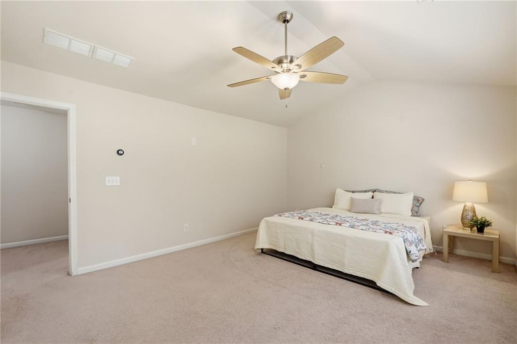 310 Hammersmith Drive Suwanee, GA 30024 - Photo 30 of 55 a bedroom with a bed and a chandelier