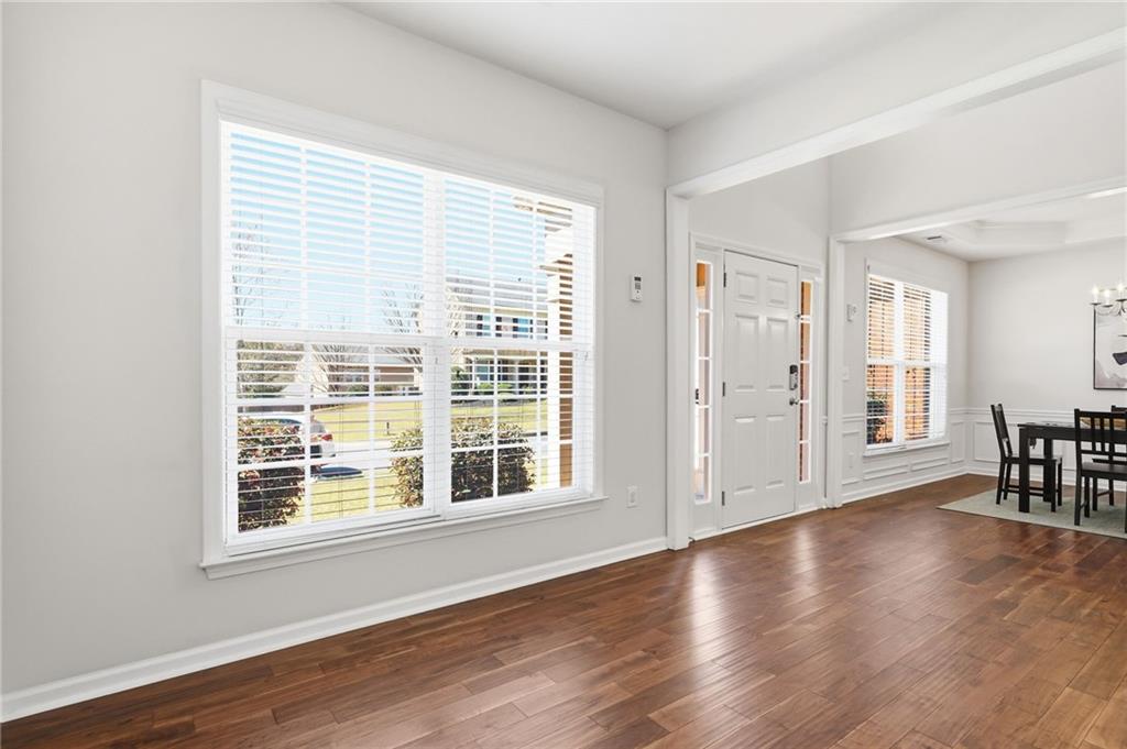 310 Hammersmith Drive Suwanee, GA 30024 - Photo 3 of 55 a view of livingroom with furniture wooden floor and windows