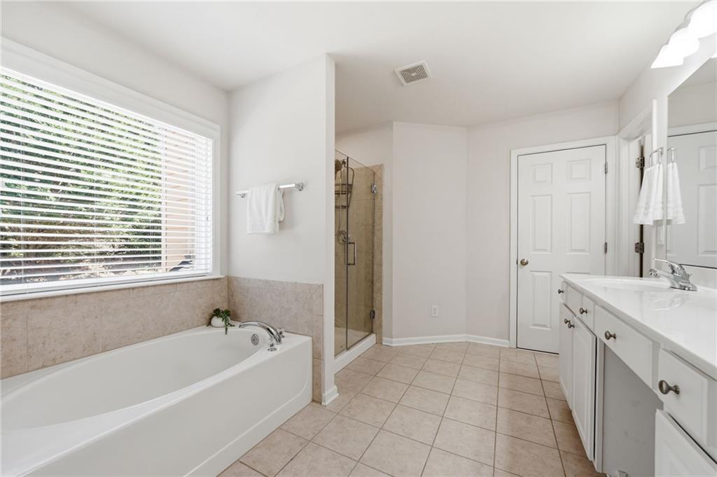310 Hammersmith Drive Suwanee, GA 30024 - Photo 33 of 55 a spacious bathroom with a tub sink and a shower