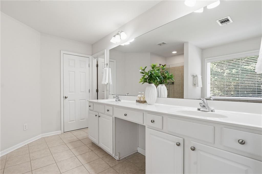 310 Hammersmith Drive Suwanee, GA 30024 - Photo 34 of 55 a spacious bathroom with a double vanity sink mirror and next