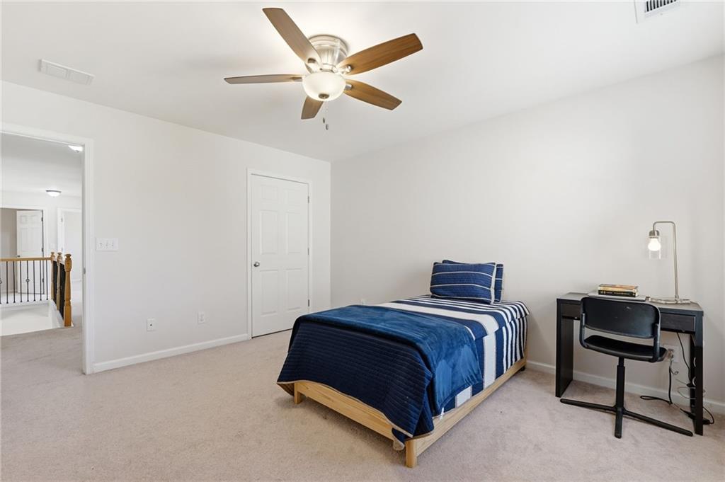 310 Hammersmith Drive Suwanee, GA 30024 - Photo 38 of 55 a bedroom with a bed and a chandelier