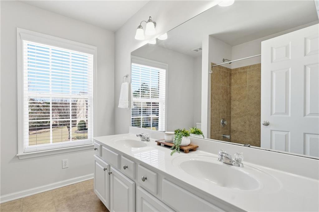 310 Hammersmith Drive Suwanee, GA 30024 - Photo 39 of 55 a bathroom with double vanity and a mirror