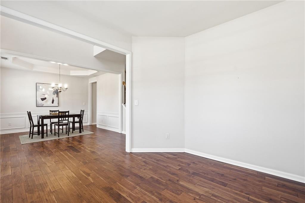 310 Hammersmith Drive Suwanee, GA 30024 - Photo 4 of 55 an empty room with wooden floor and windows