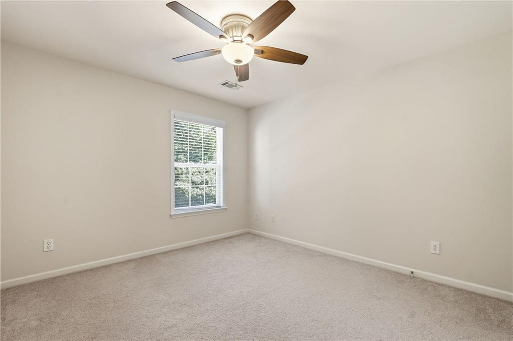 310 Hammersmith Drive Suwanee, GA 30024 - Photo 43 of 55 an empty room with a window and a fan