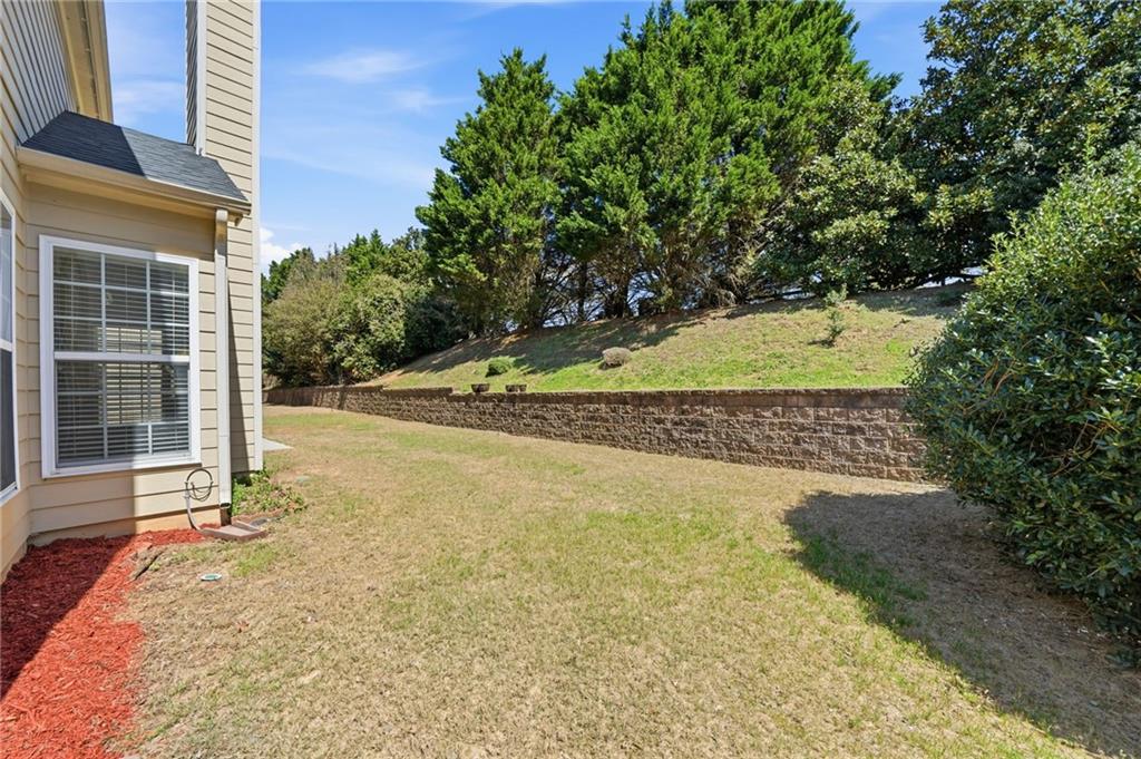 310 Hammersmith Drive Suwanee, GA 30024 - Photo 48 of 55 a view of a house with a yard