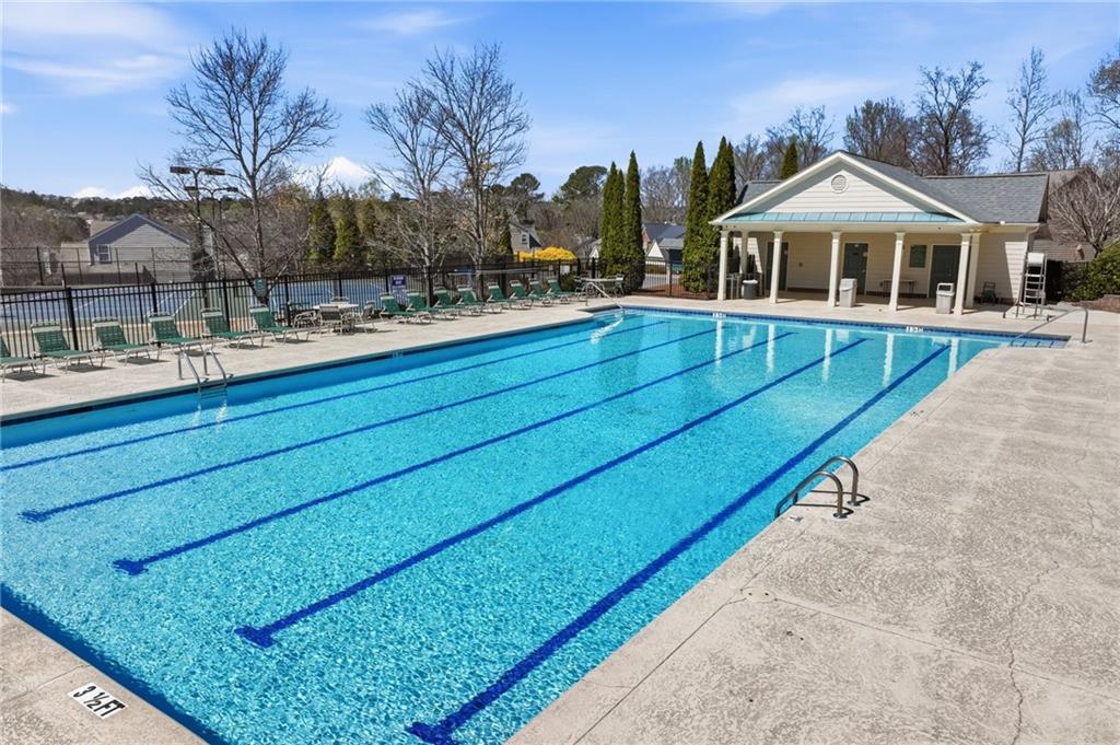 310 Hammersmith Drive Suwanee, GA 30024 - Photo 51 of 55 a view of swimming pool with outdoor seating and house in the background