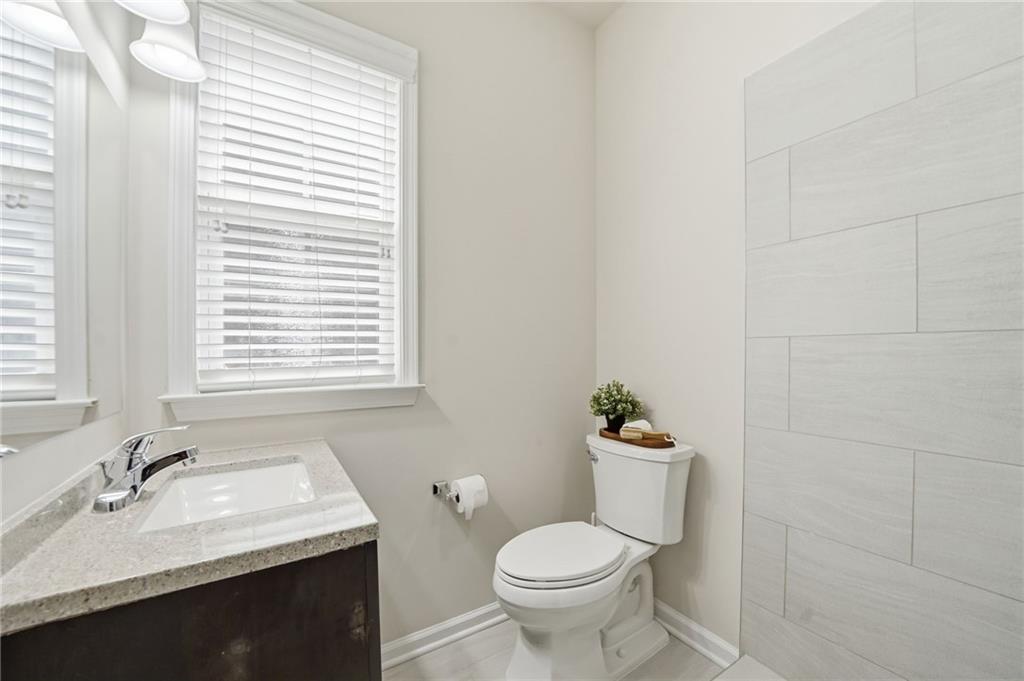 310 Hammersmith Drive Suwanee, GA 30024 - Photo 7 of 55 a bathroom with a sink a toilet and window