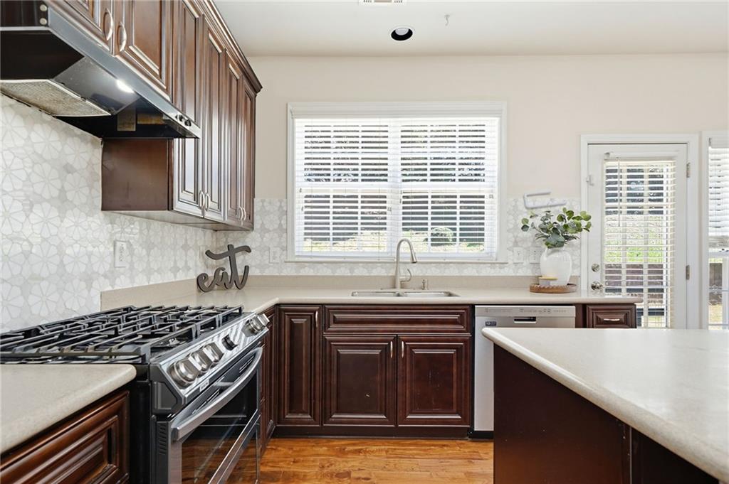 310 Hammersmith Drive Suwanee, GA 30024 - Photo 10 of 55 a kitchen with a sink stove top oven and cabinets