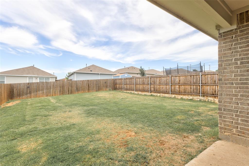 1016 Rio Bravo Drive Forney, TX 75126 - Photo 21 of 25 Private backyard featuring a wooden privacy fence, a concrete patio, and a grass lawn