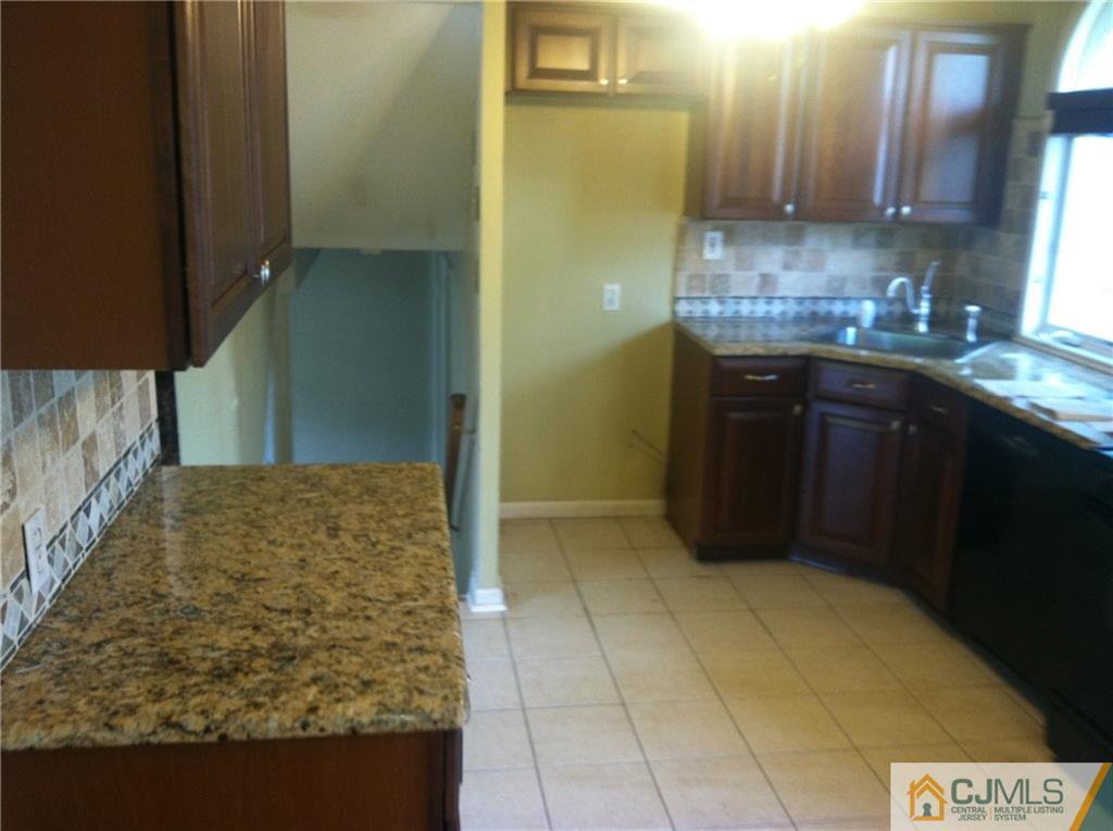 9 Eastlick Road Edison, NJ 08817 - Photo 2 of 20 a bathroom with a granite countertop sink and a mirror