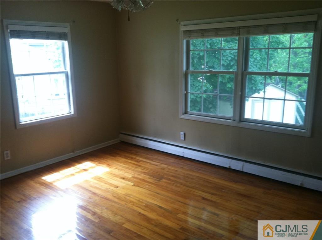 9 Eastlick Road Edison, NJ 08817 - Photo 4 of 20 a view of an empty room with wooden floor and a window