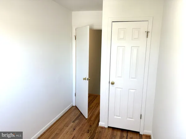 a view of hallway with wooden floor