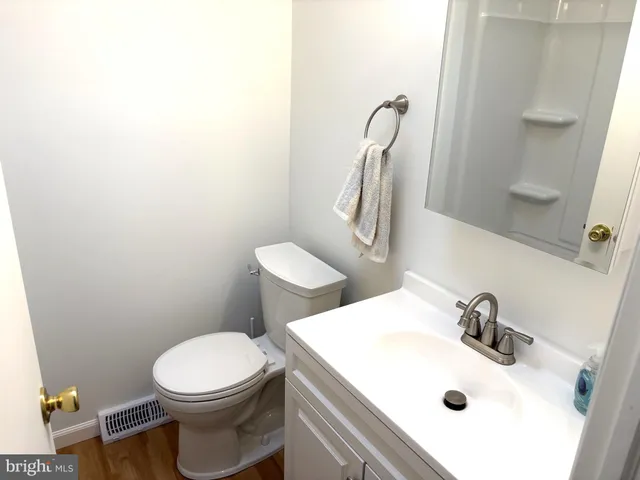 a white toilet sitting next to a bathroom sink